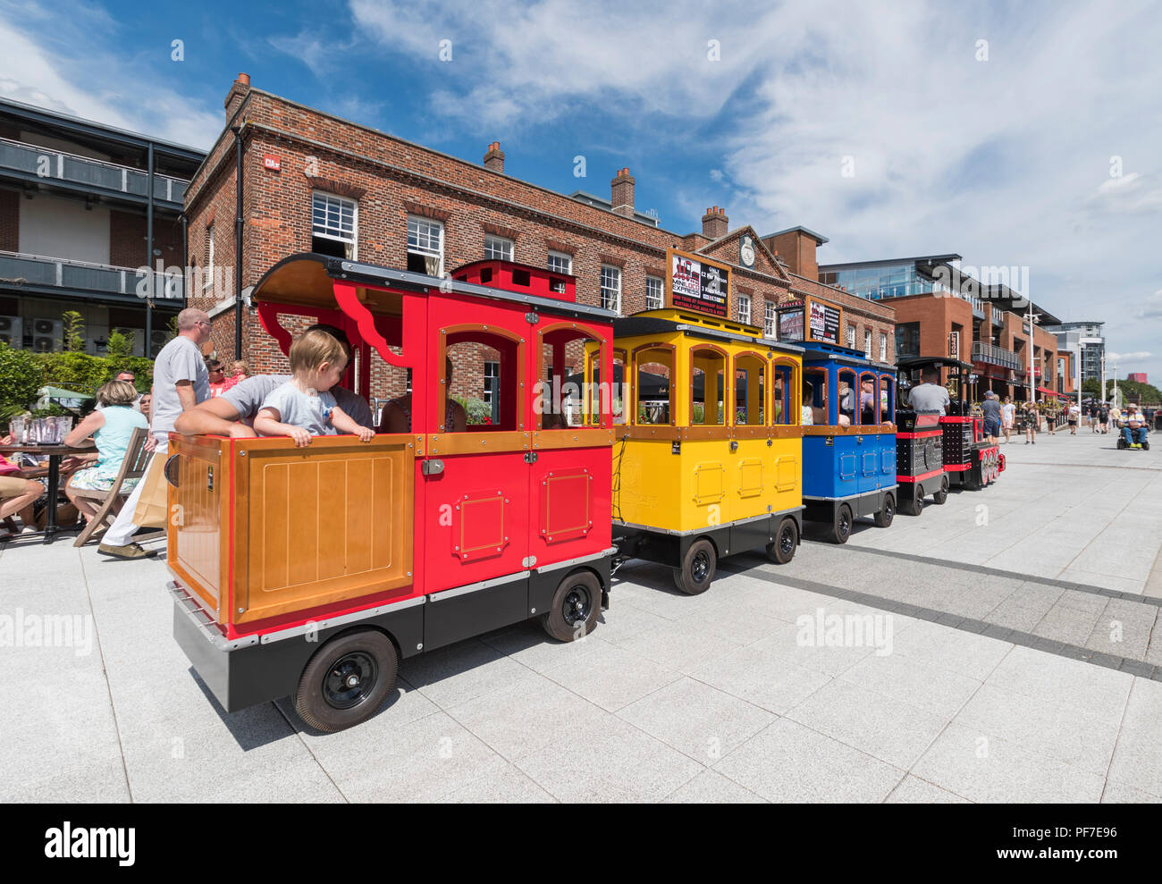 The Mini Loco Express road train in Gunwharf Quays, Portsmouth, Hampshire, England, UK. Stock Photo