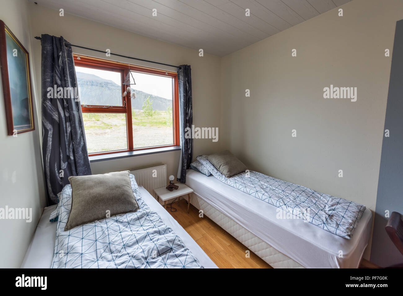 https://c8.alamy.com/comp/PF7G0K/clean-european-twin-two-beds-comforter-with-table-lamp-decorations-window-in-bedroom-staging-model-home-guest-house-apartment-in-hostel-hotel-roo-PF7G0K.jpg