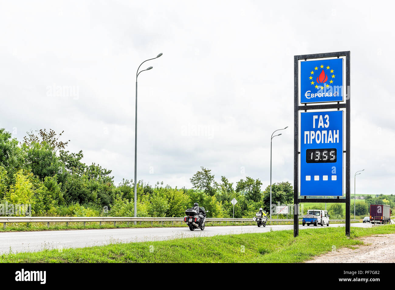 Rivne, Ukraine - July 23, 2018: Evrogas, Eurogas gas station fueld pump sign by road in Western Ukraine with propane price sign in hryvnia, cars on hi Stock Photo