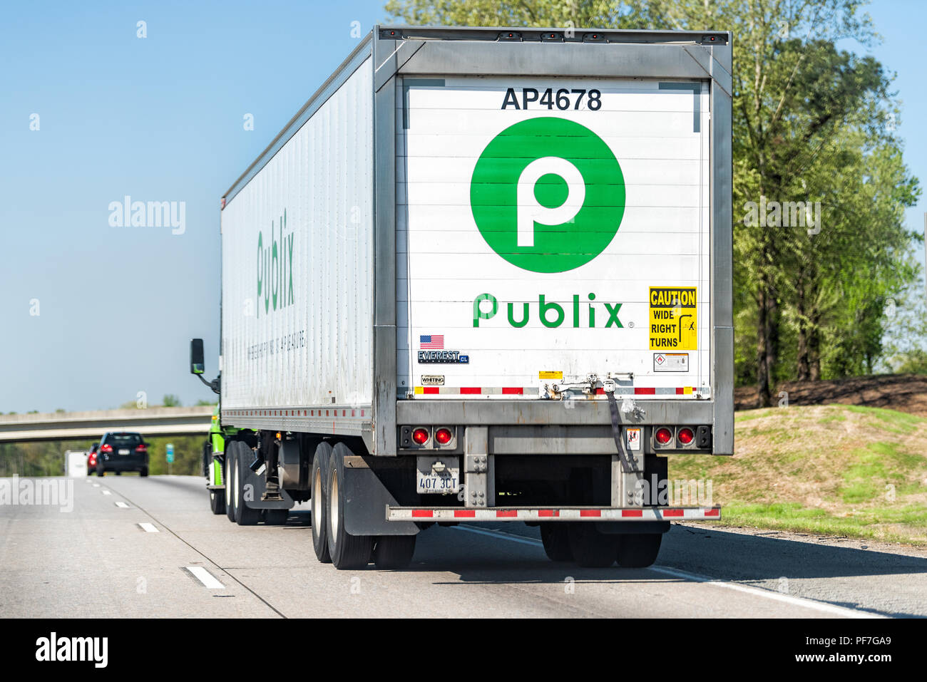 Atlanta, USA - April 20, 2018: Back of Publix grocery store delivery truck closeup on highway road with green sign Stock Photo