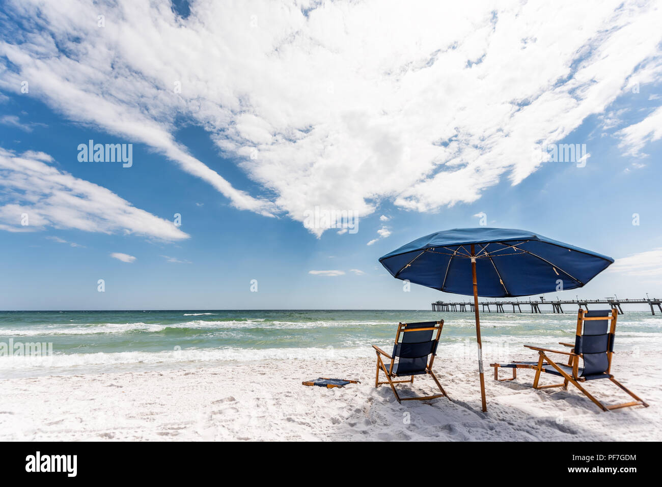 https://c8.alamy.com/comp/PF7GDM/okaloosa-fishing-pier-in-fort-walton-beach-florida-during-day-in-panhandle-gulf-of-mexico-during-sunny-day-two-empty-beach-chairs-and-umbrella-PF7GDM.jpg