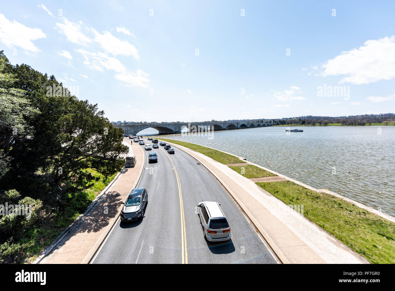 Washington DC, USA - April 5, 2018: Aerial view of Rock Creek Park Parkway highway road street below with Potomac River water, boat, bridge in spring, Stock Photo