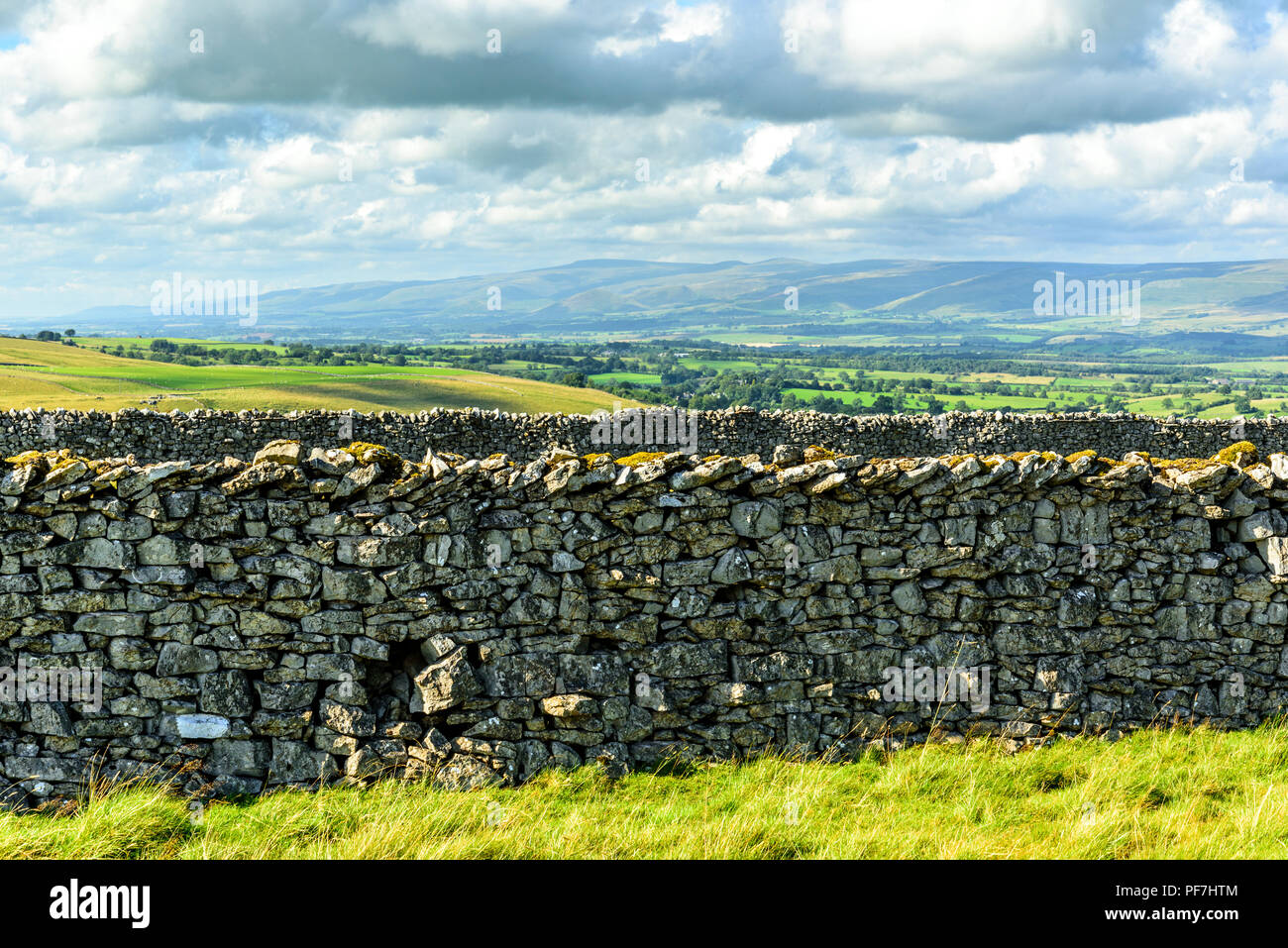 Limestone walls on Smardale Fell near Kirkby Stephen, Cumbria, with the Eden Valley, Cross Fell, and the North Pennines in the distance. Stock Photo