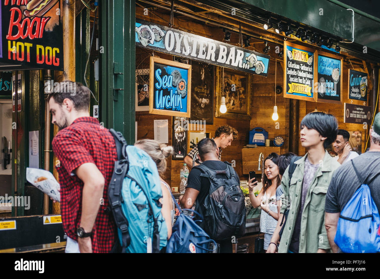 London, UK July 24, 2018 Seller and customer at an oyster bar in