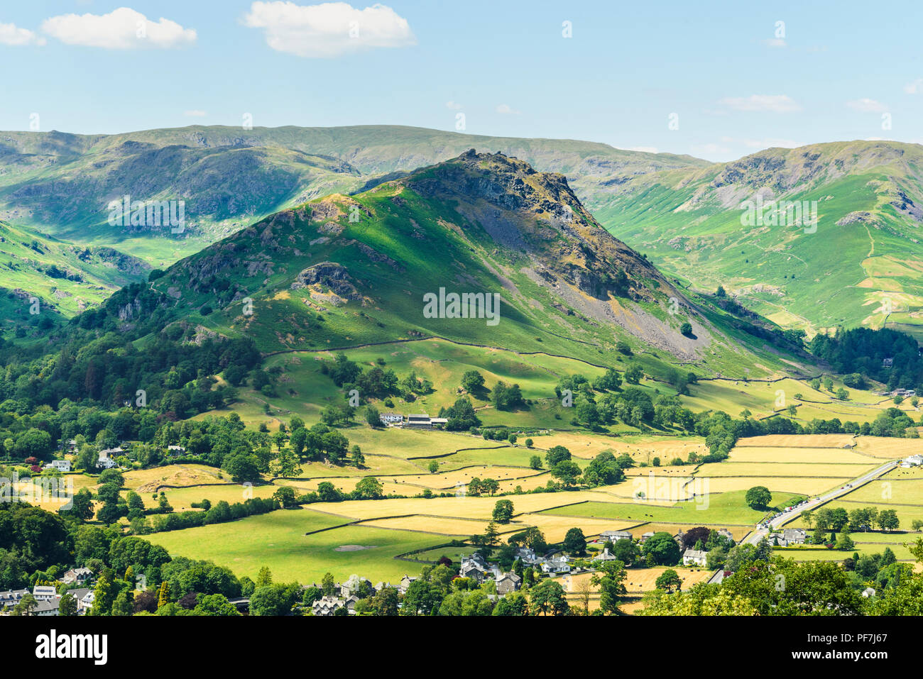 Helm Crag (centre), near Grasmere in the Lake District, with Ullscarf on central skyline and Steel Fell on right. Stock Photo