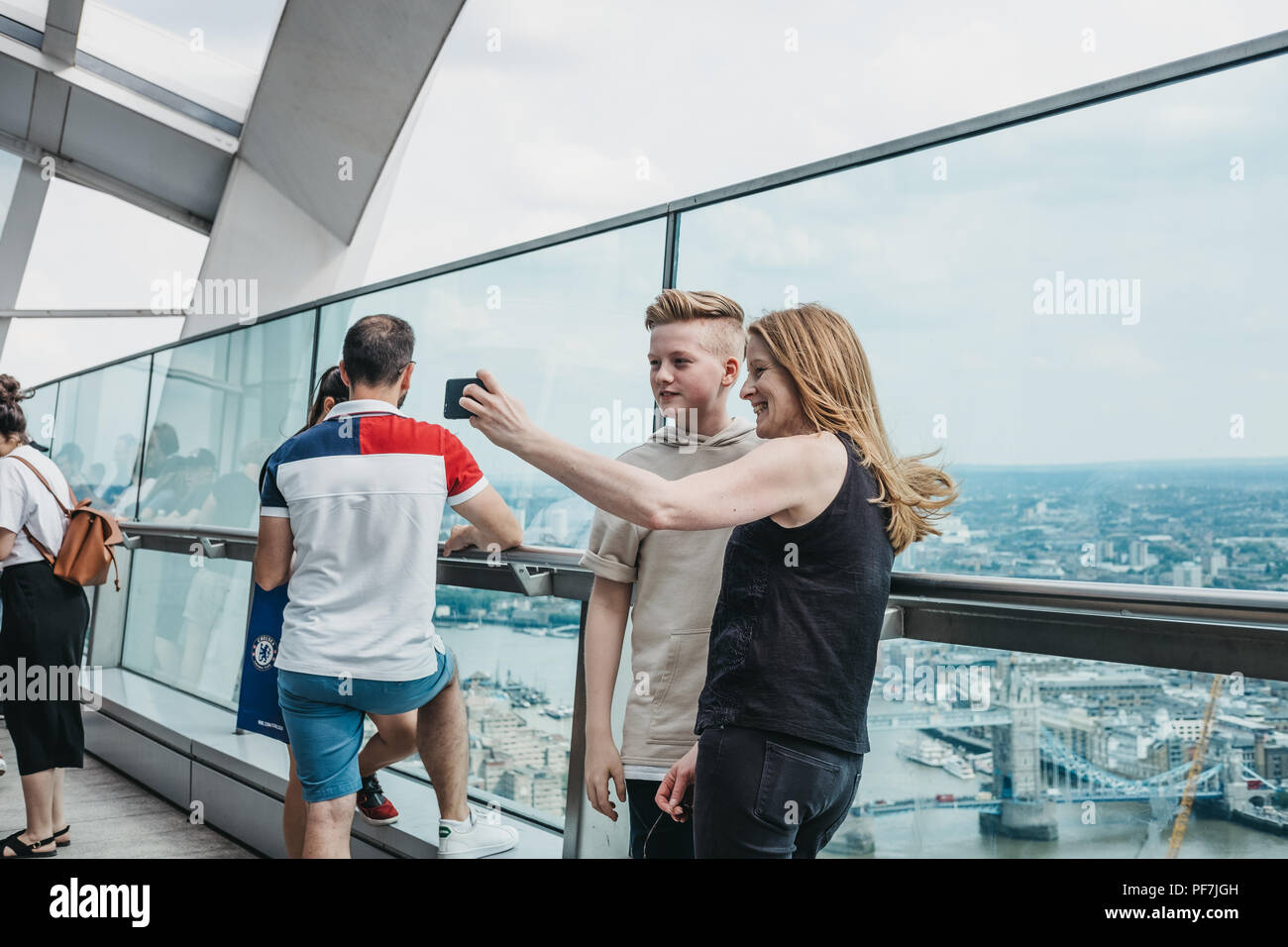 London, UK - June 24, 2018: People taking selfies on an open air balcony in Sky Garden, the highest public garden in London located in a glass dome wi Stock Photo