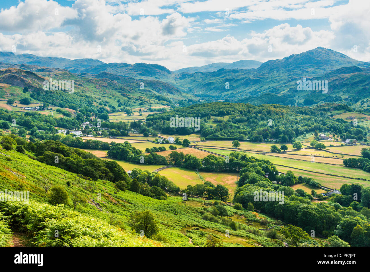 The village of Boot and upper Eskdale from Hollinghead Bank in the Lake District. Harter Fell on right and Hardknott Pass nearer centre. Stock Photo