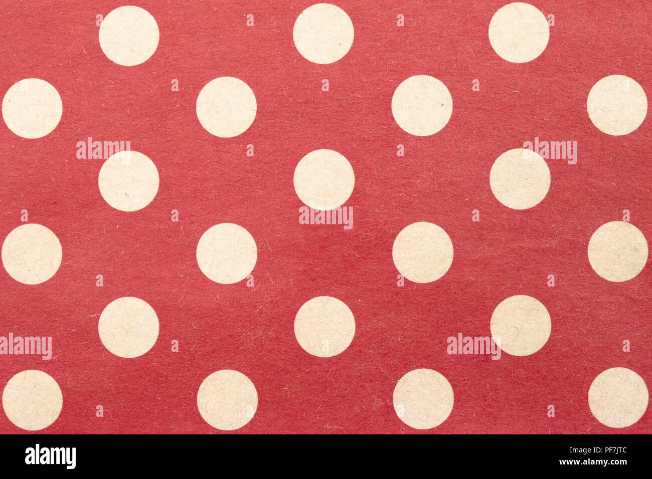 White polka dots on red background, paper surface background Stock Photo