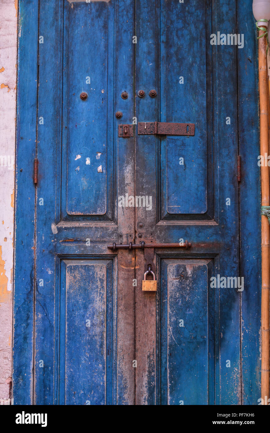 Old Locked Wooden Door With An Iron Lock In A Gloomy House