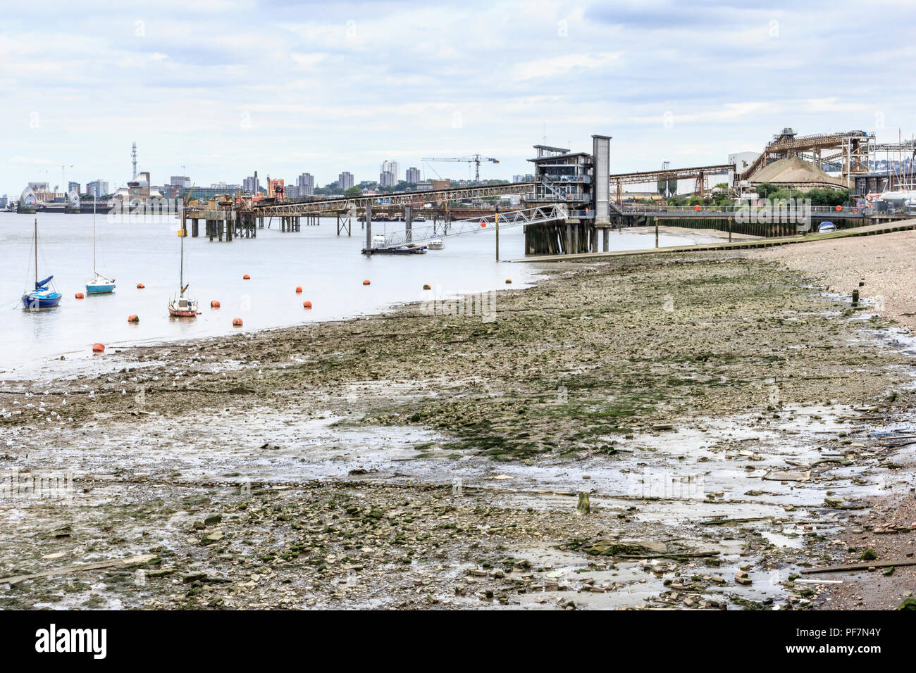 The muddy shore of the River Thames at low tide, North Greenwich, London, UK Stock Photo