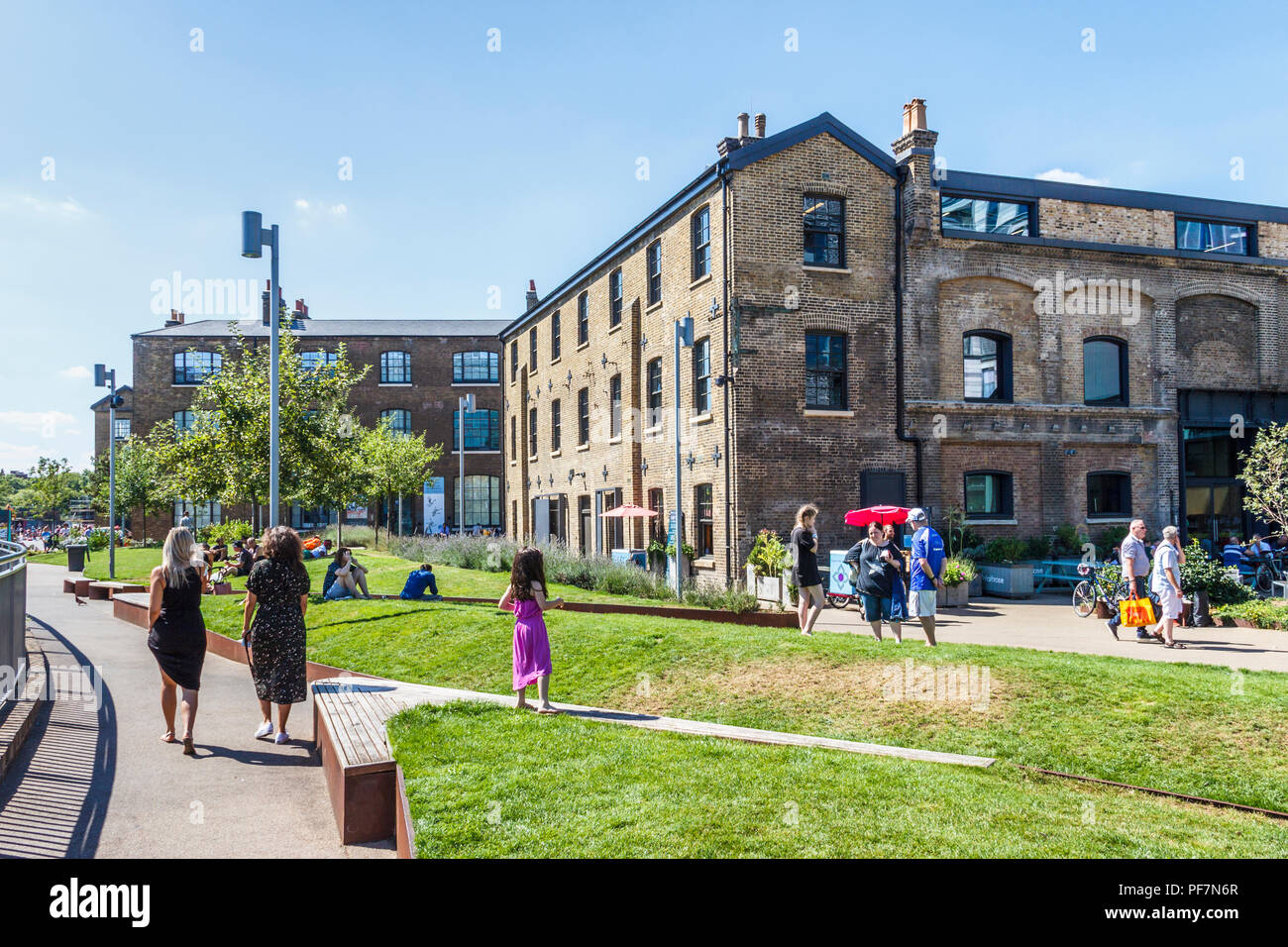 As temperatures rise Londoners sun themselves by Regent's Canal at King's Cross, London, UK Stock Photo