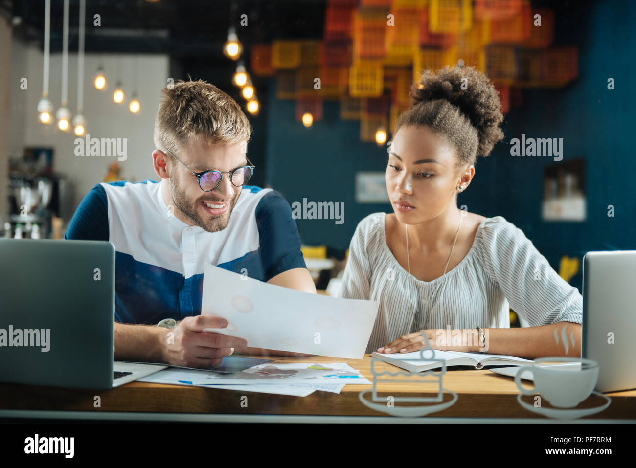 Hardworking involved freelancers looking at some documents Stock Photo