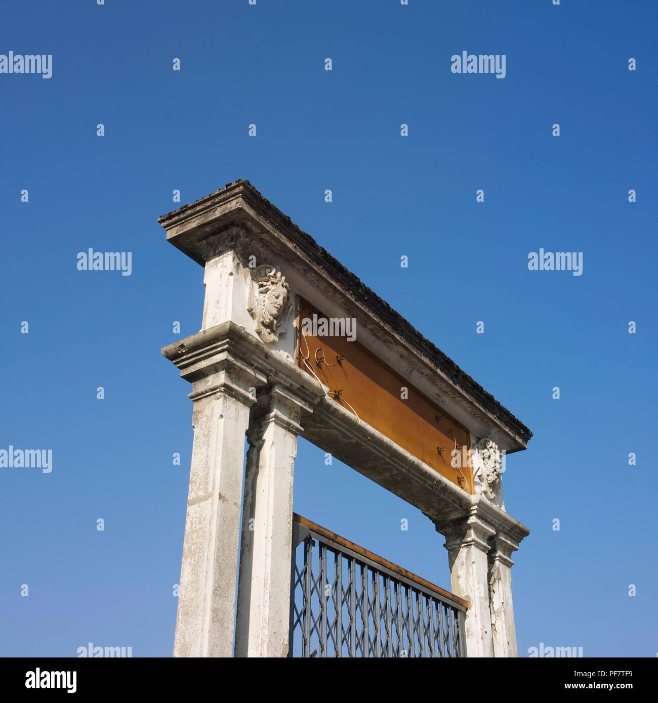 View from below of two pillars topped with sculpture on a blue sky cloudless, France Stock Photo