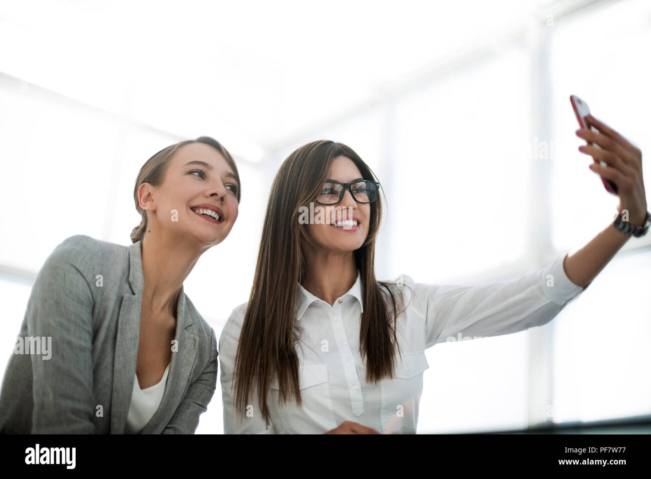 two attractive business women take selfies Stock Photo - Alamy