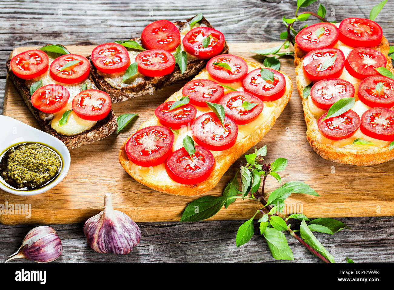 Caprese Garlic Ciabatta hot Bread toasts with mozzarella cheese, tomatoes Stock Photo Alamy
