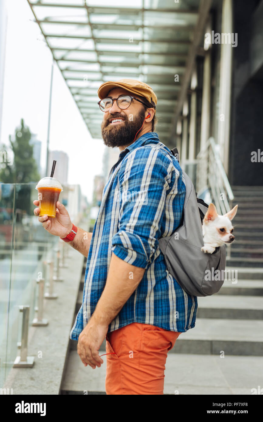 Bearded man going to business center drinking some ice coffee Stock Photo
