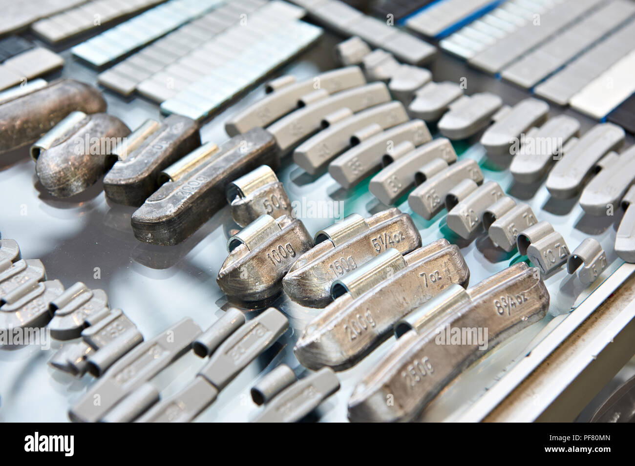 Balancing weights for car wheels in shop Stock Photo Alamy