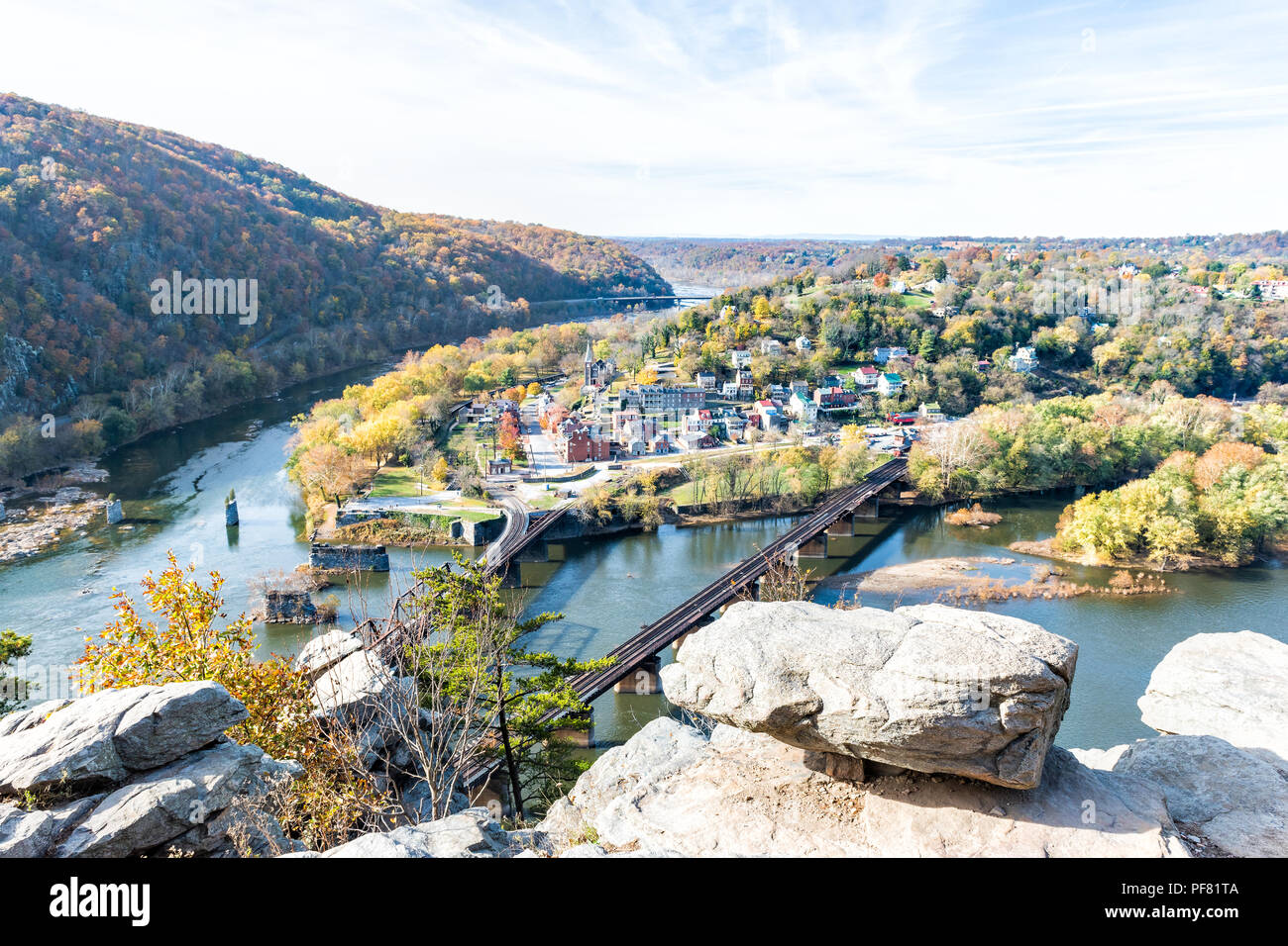 Harper's Ferry overlook with colorful orange yellow foliage during fall, autumn forest with small village town by river in West Virginia, WV Stock Photo