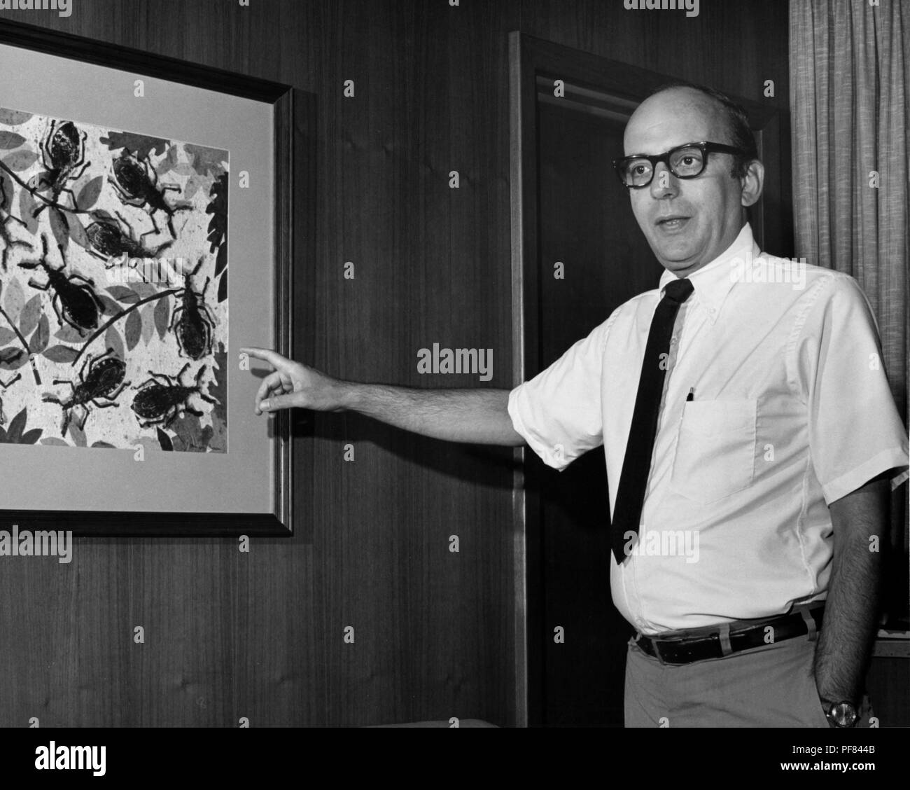 Former Centers for Disease Control (CDC) Director Dr David J Sencer pointing to a piece of artwork, 1970. Image courtesy Centers for Disease Control / Betty Loy. () Stock Photo