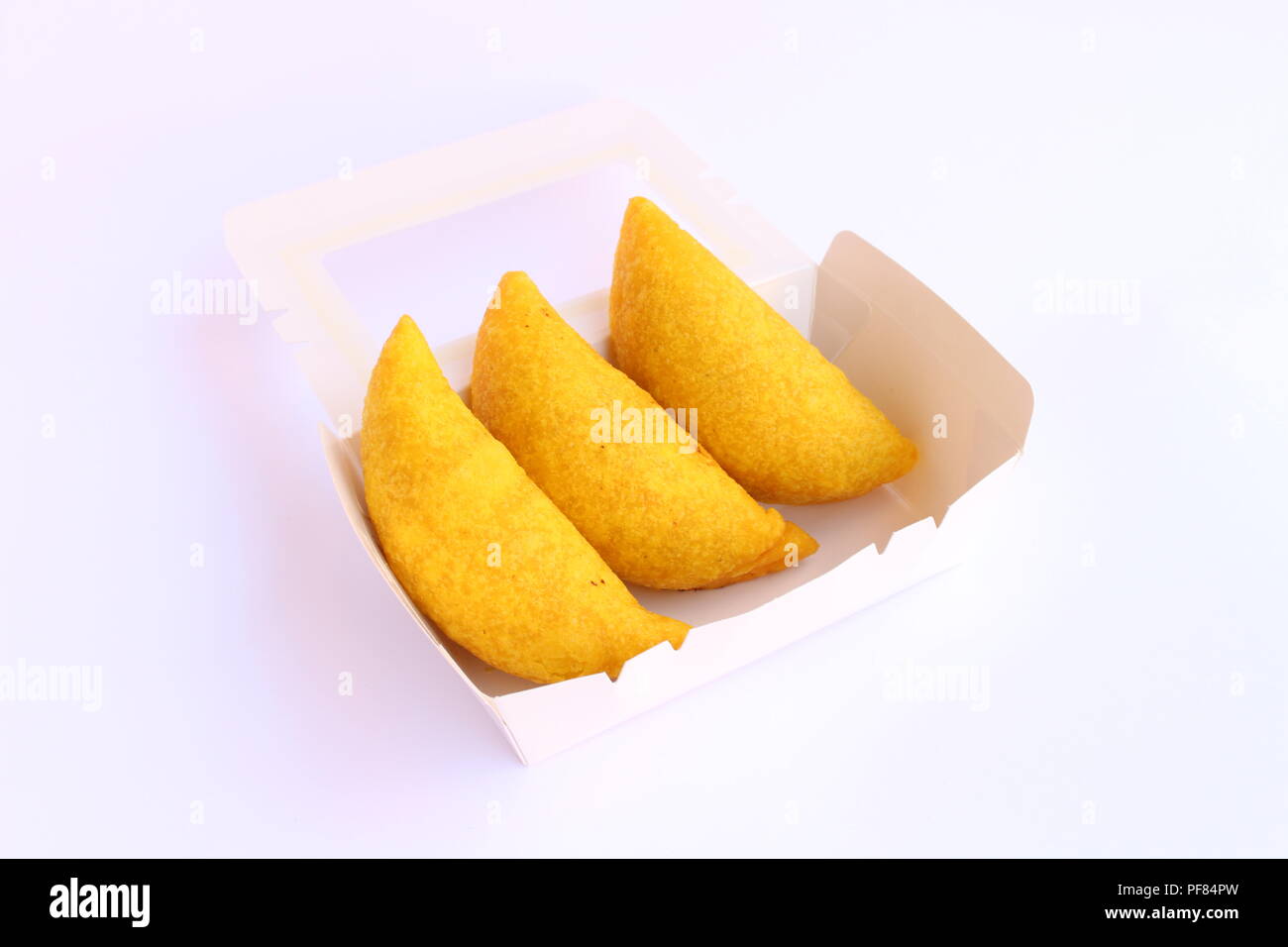 Traditional empanadas, colombian breaded wrap made by folding dough over a stuffing, which may consist of meat, cheese, or other ingredients. Stock Photo