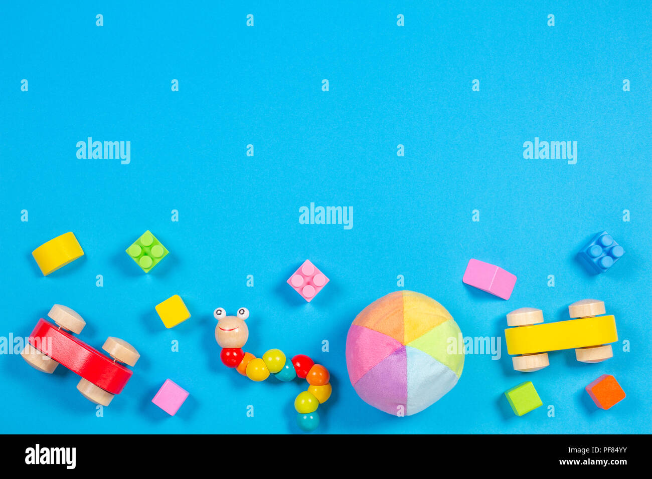 Baby Kids Toys Background Wooden Car Colorful Bricks And Soft Toys On Blue Background Top View Stock Photo Alamy