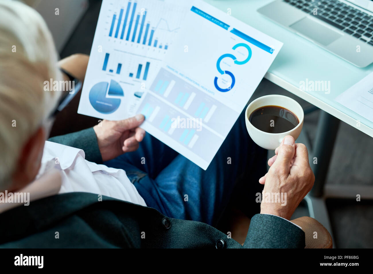 Unrecognizable Senior Businessman Working in Cafe Stock Photo