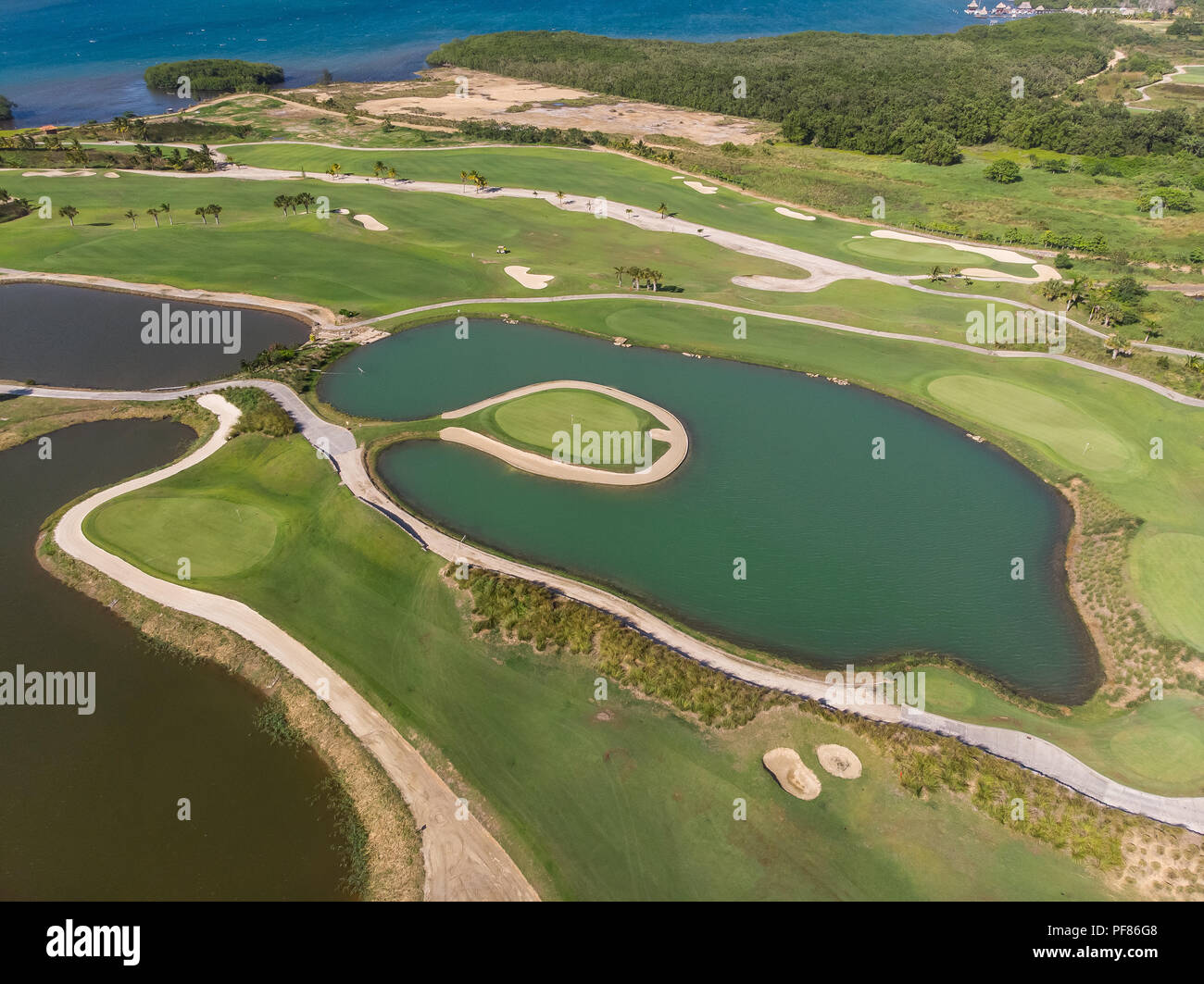 Aerial View of Putting Green Surrounded By Water Stock Photo