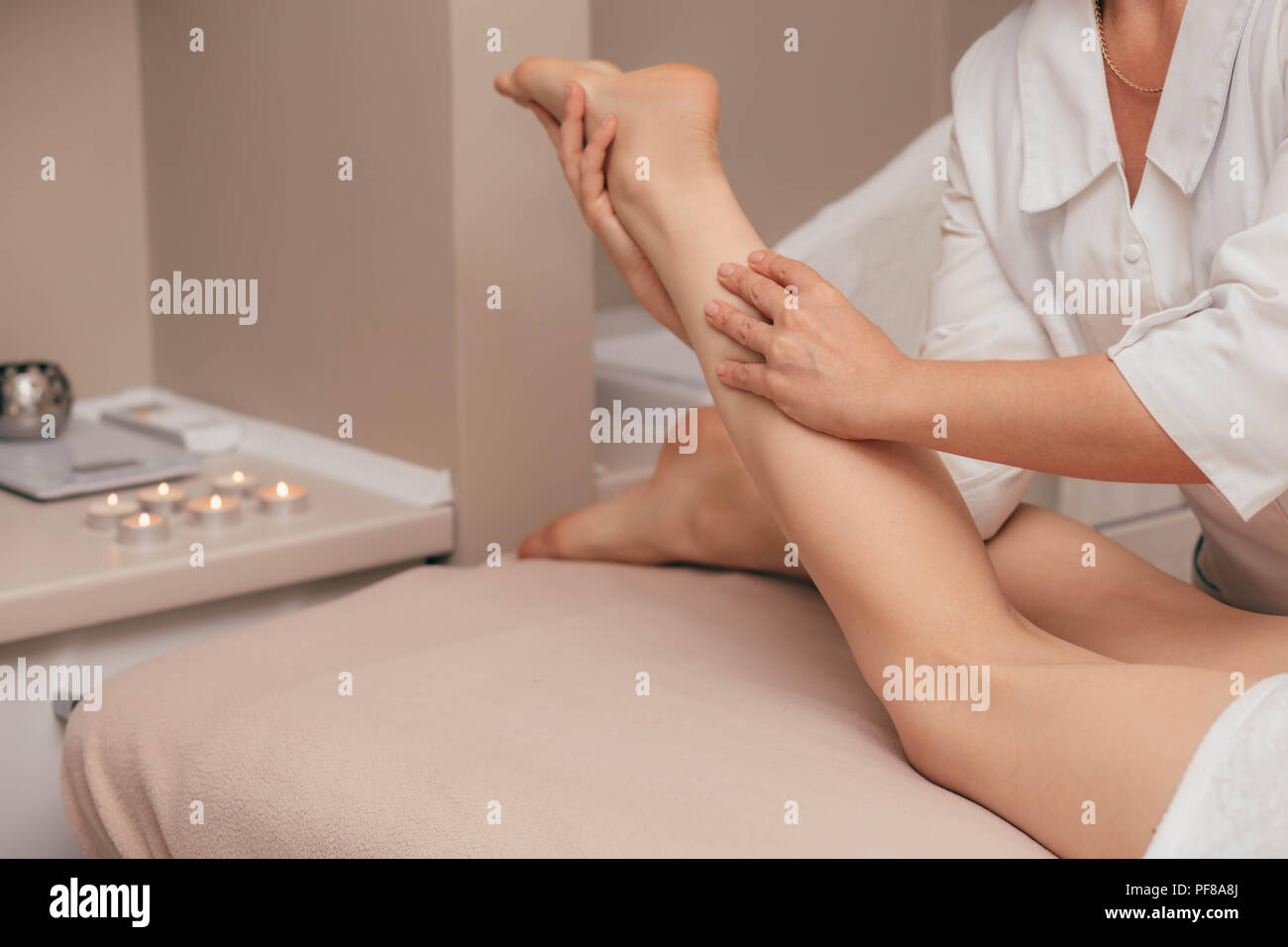 Woman having sports foot massage.rejuvenating foot massage for athletes in Spa Salon Stock Photo