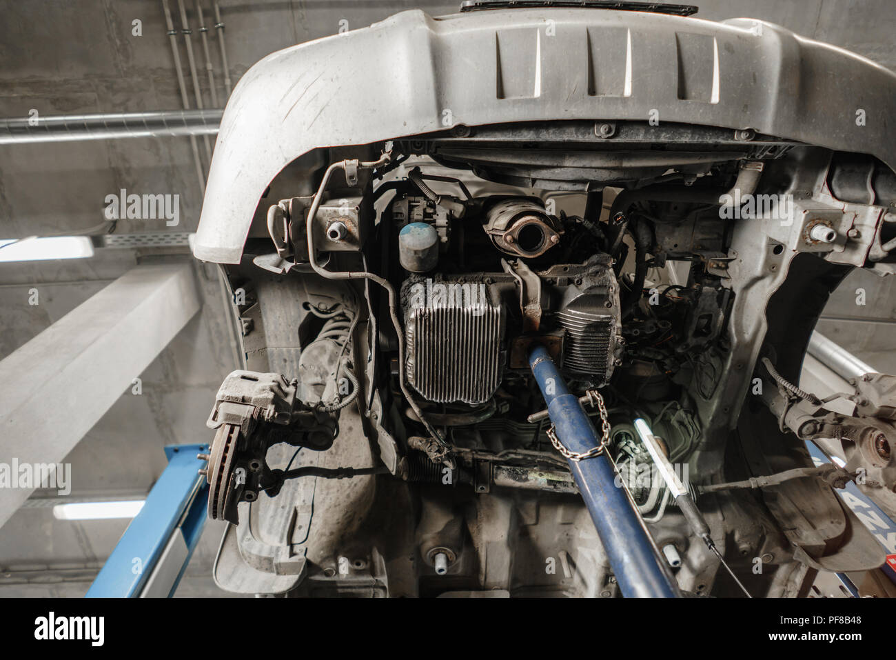 Change and repair clutch, drive axle. working underneath a lifted car