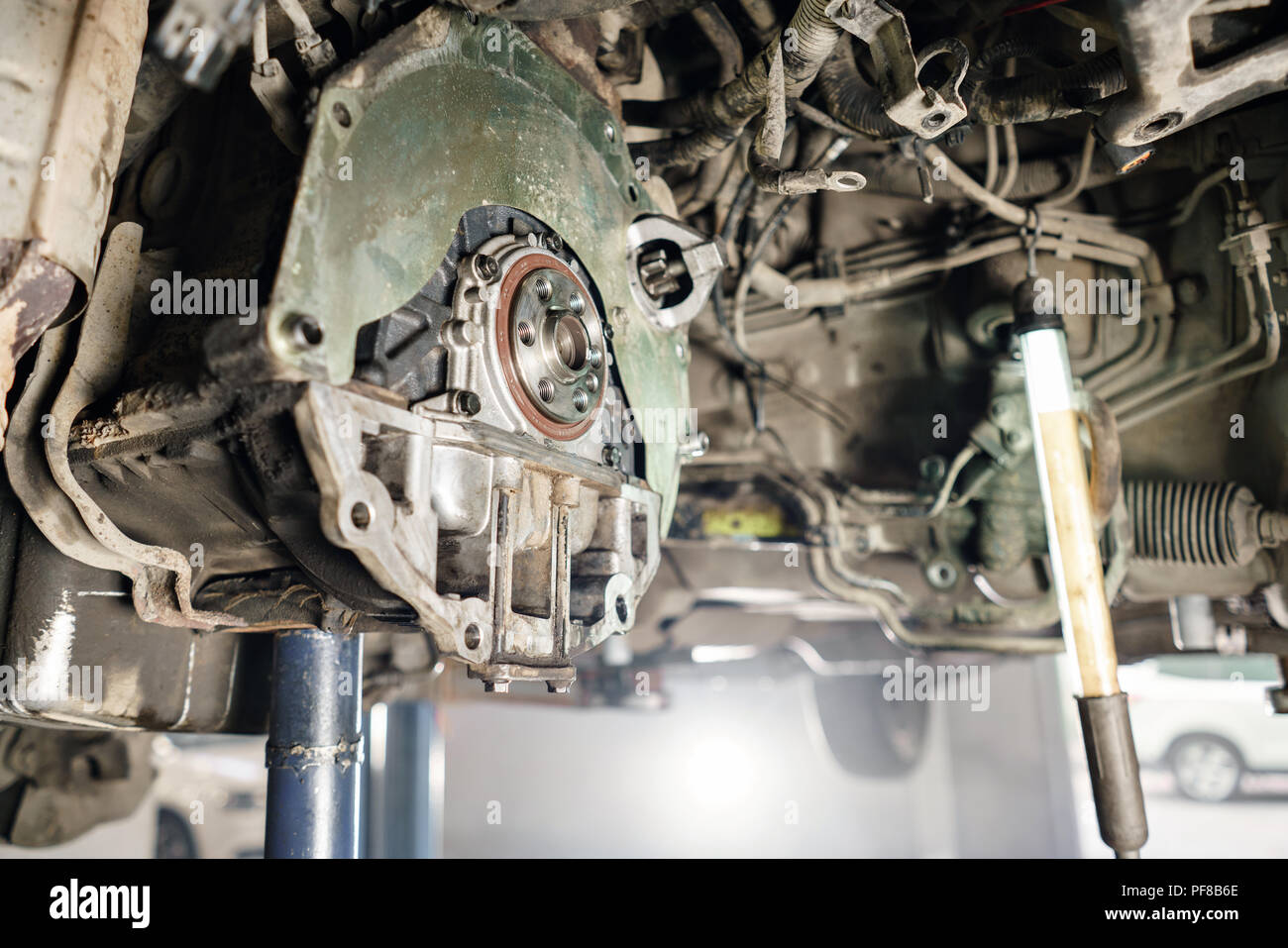 Change and repair clutch, drive axle. working underneath a lifted car