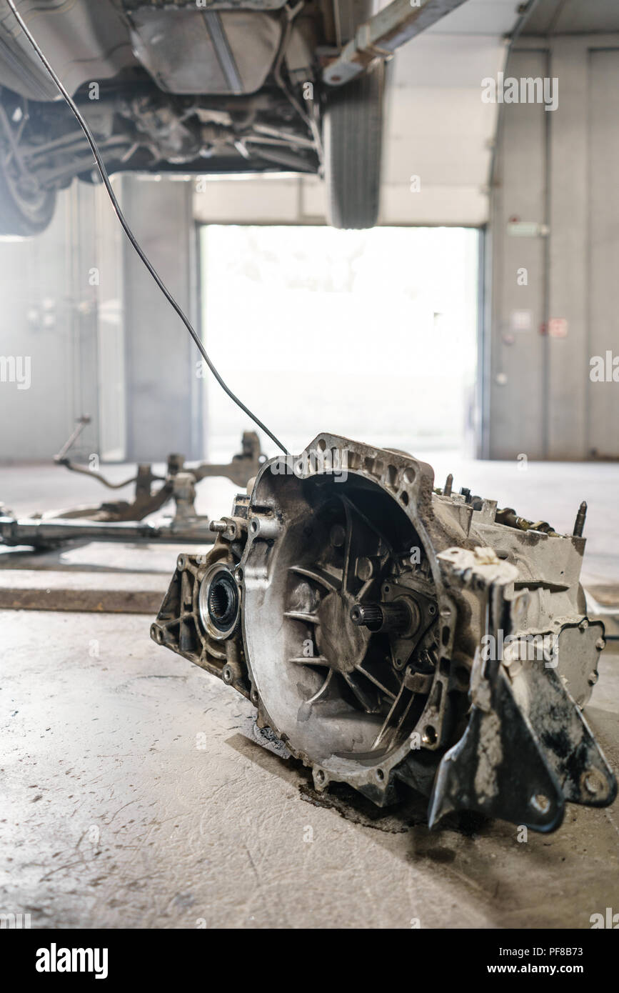 Change and repair clutch, drive axle. working underneath a lifted car