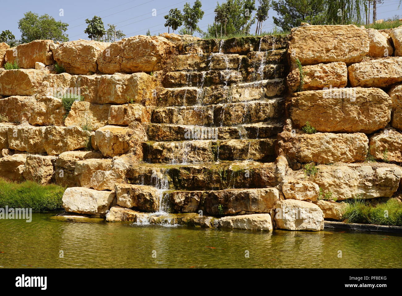 Artificial ornamental waterfall in a manmade park Stock Photo