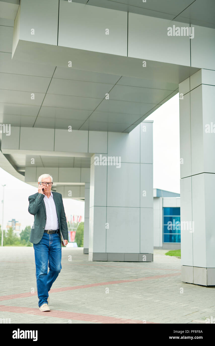 Elderly man walking phone hi-res stock photography and images - Alamy