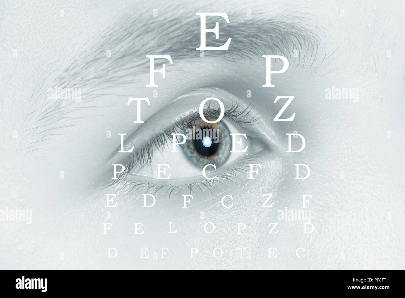 Young man on eyesight test chart background Stock Photo