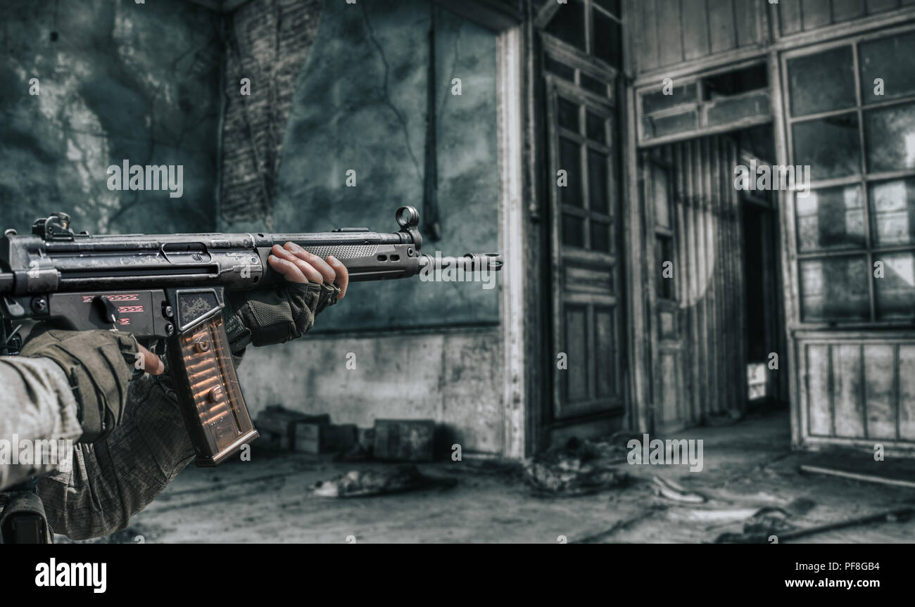 Close-up of man shooting with machine gun. Stock Photo