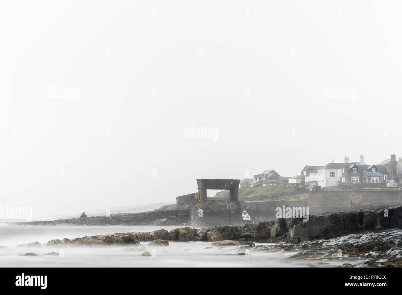 Misty summer morning producing a high key effect, looking towards the village of Craster on the Northumbrian Coast, Northumberland, England Stock Photo