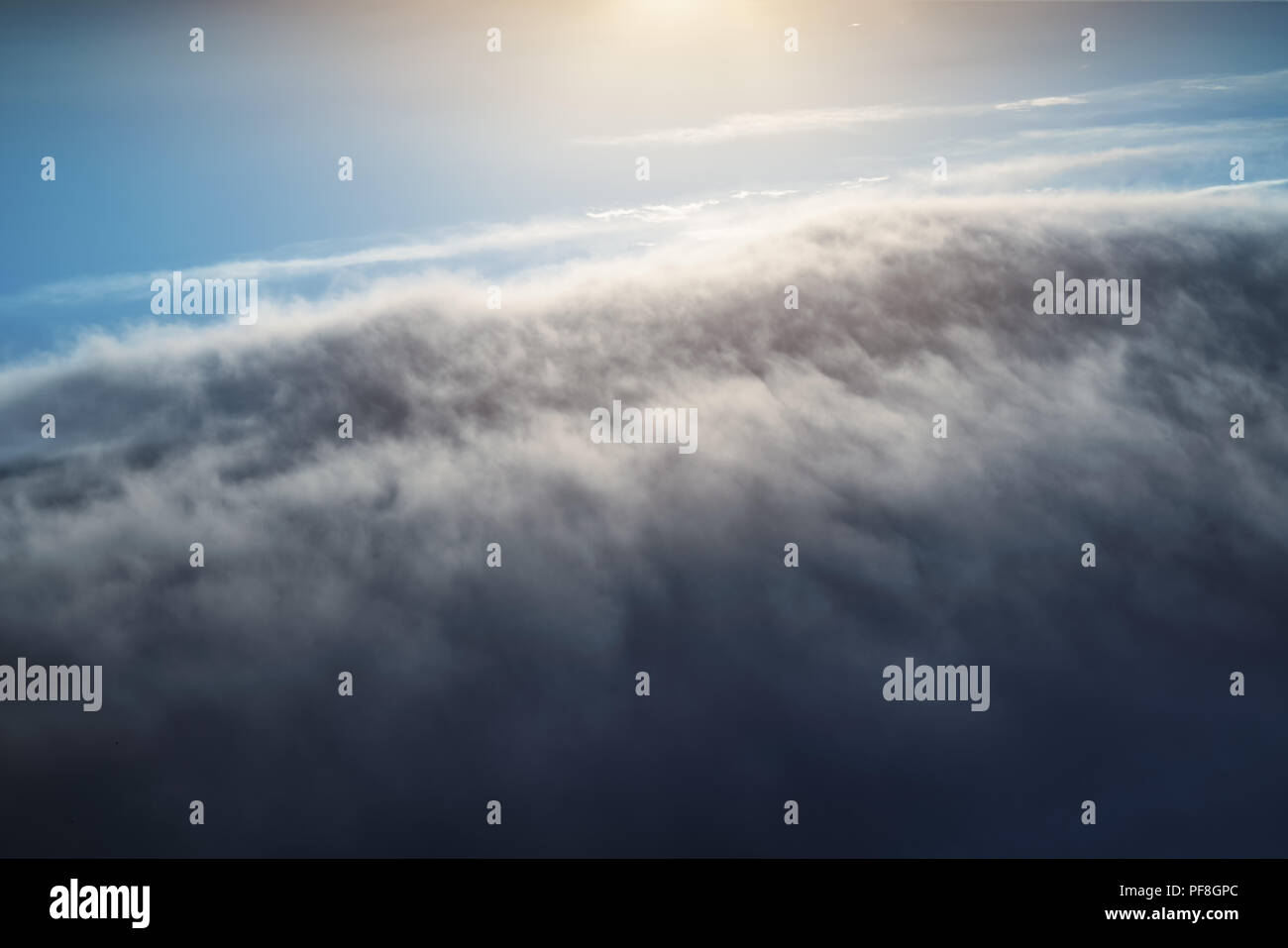 Aial view of clouds and blue skies above the earth. Stock Photo