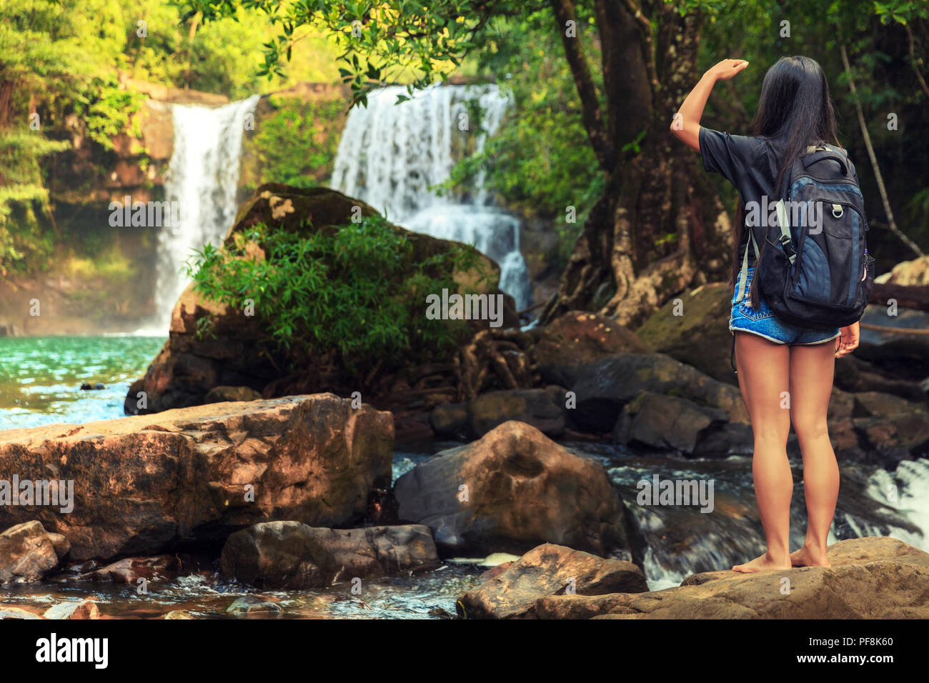 Travel tourist woman explore waterfall hidden in jungle Tropical ...