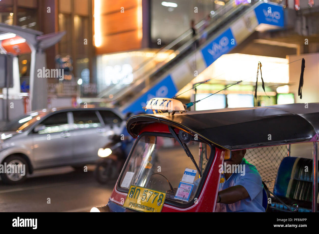 Jan11,2016 : Bangkok Thailand - 5778 Thai number plate on Tuk-Tuk parking on the rond with vivo logo in background. Stock Photo