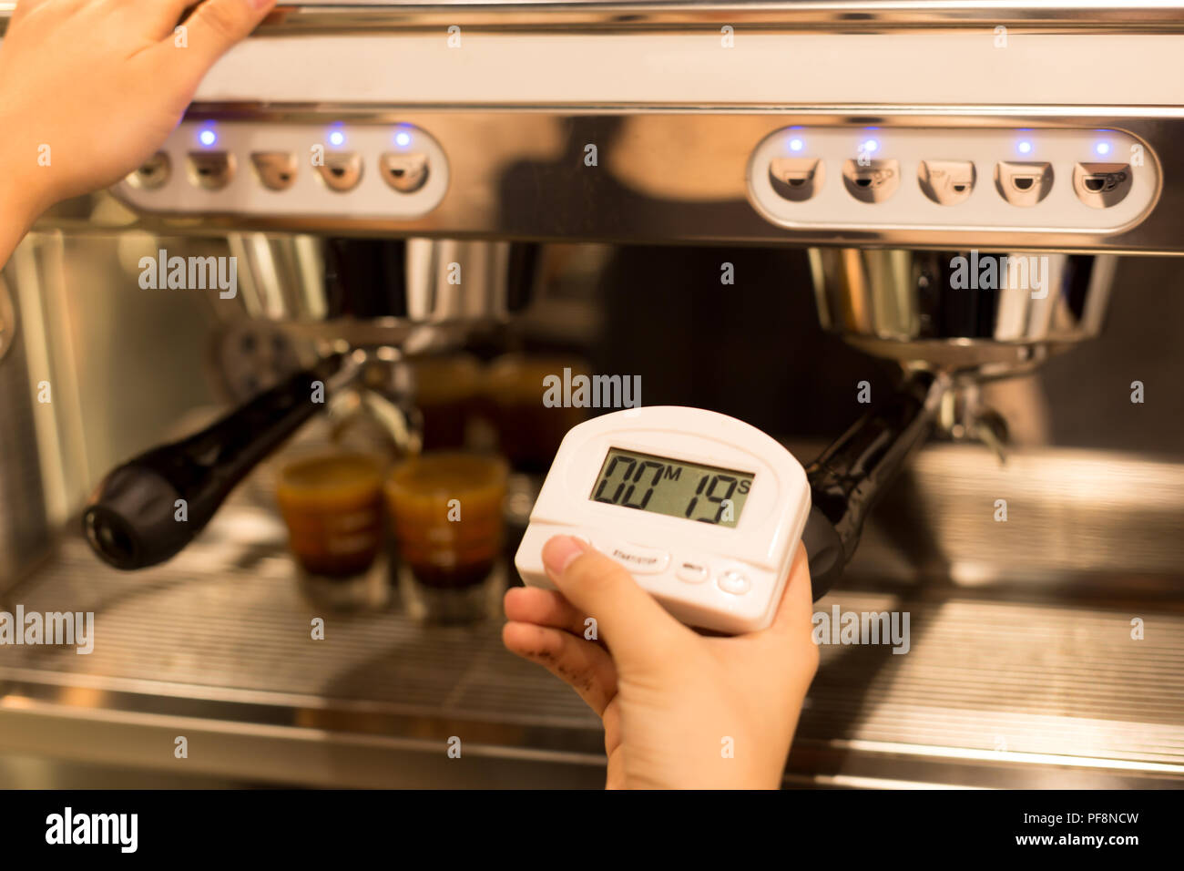 Barista hand holding stopwatch making a espresso Stock Photo Alamy
