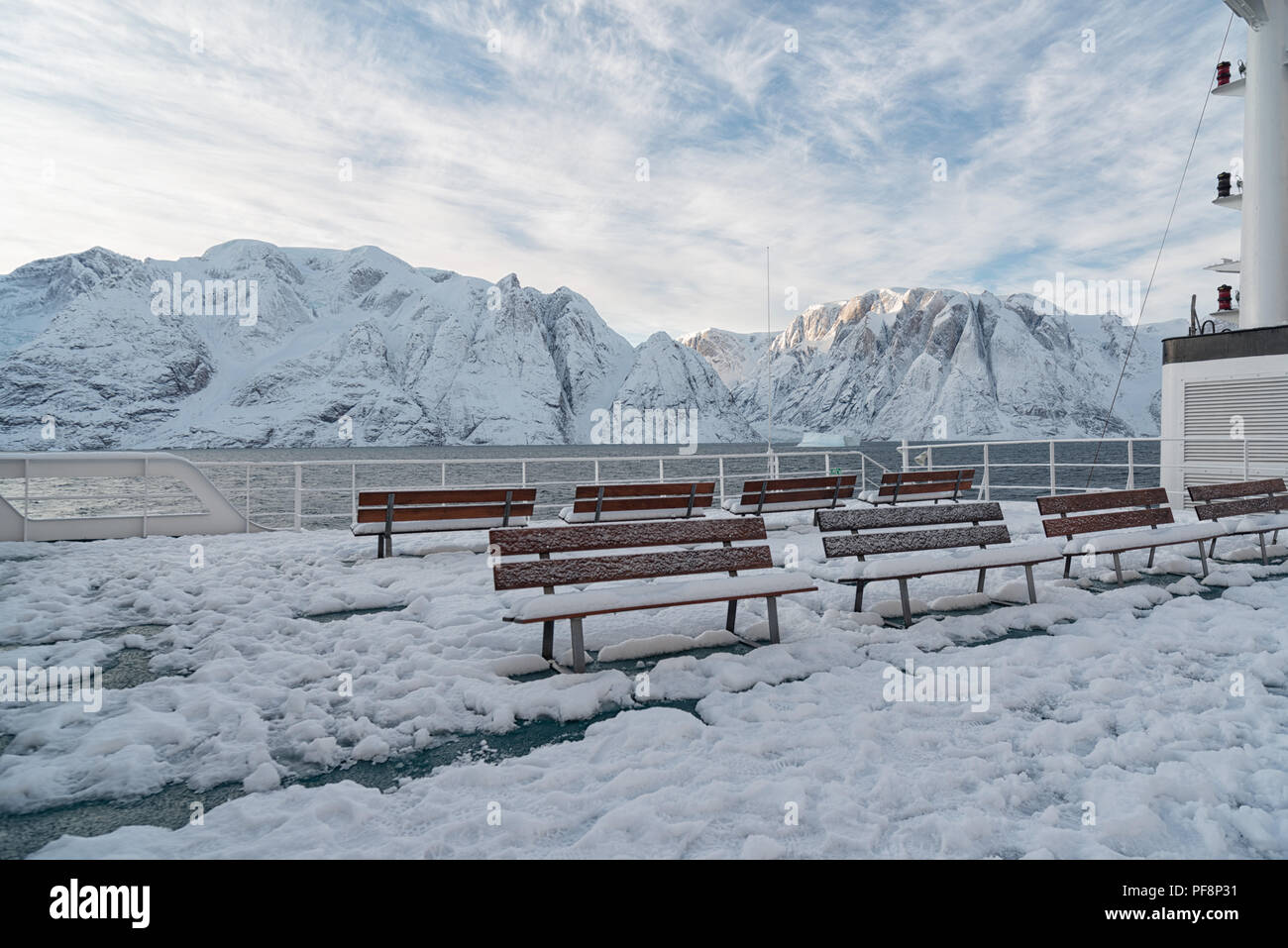 View from a ship, covered with snow, to the landscape of fjord Øfjord, part of Scoresby Sund, Kangertittivaq, in Greenland Stock Photo