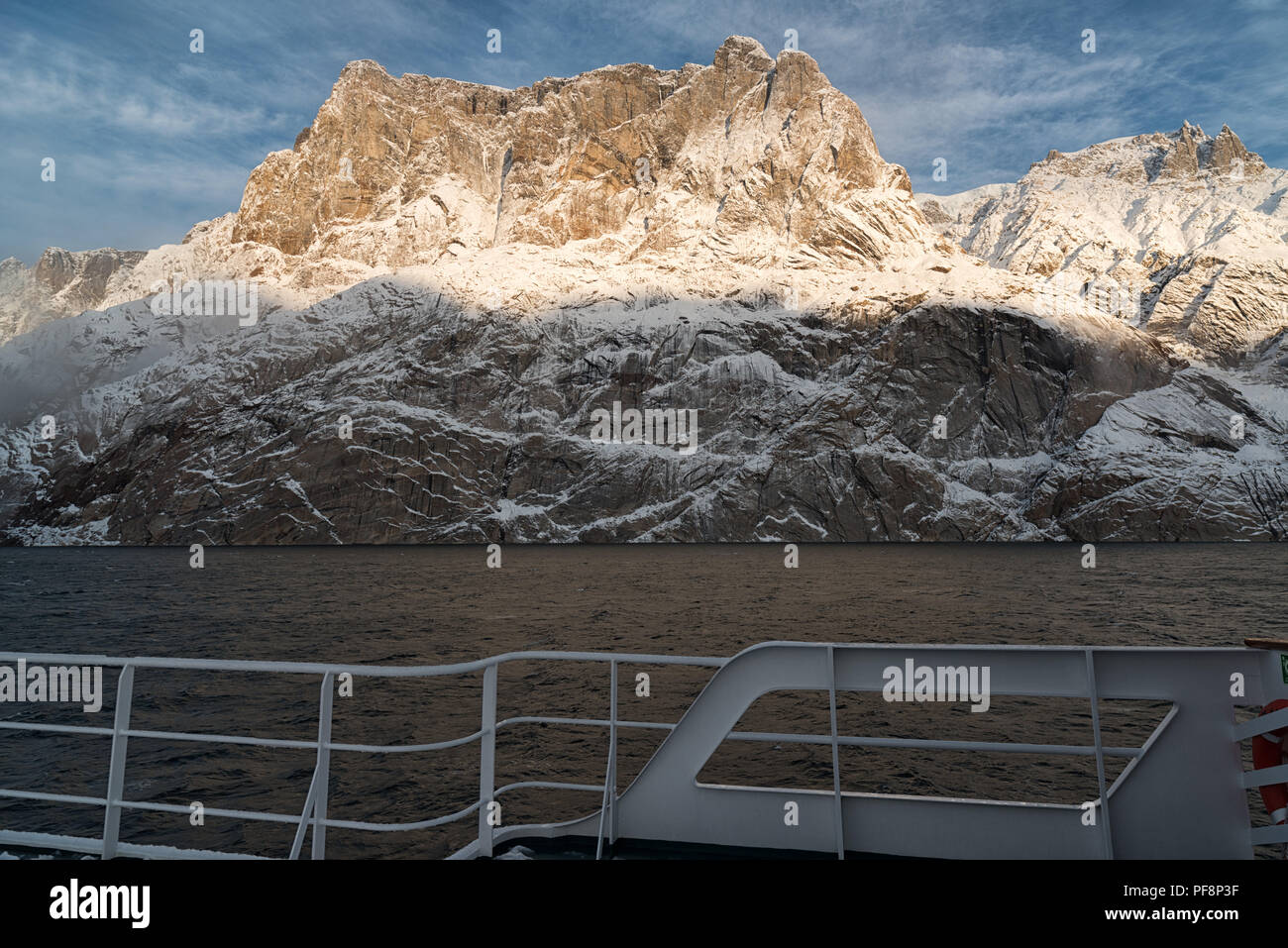 View from a ship, covered with snow, to the landscape of fjord Øfjord, part of Scoresby Sund, Kangertittivaq, in Greenland Stock Photo