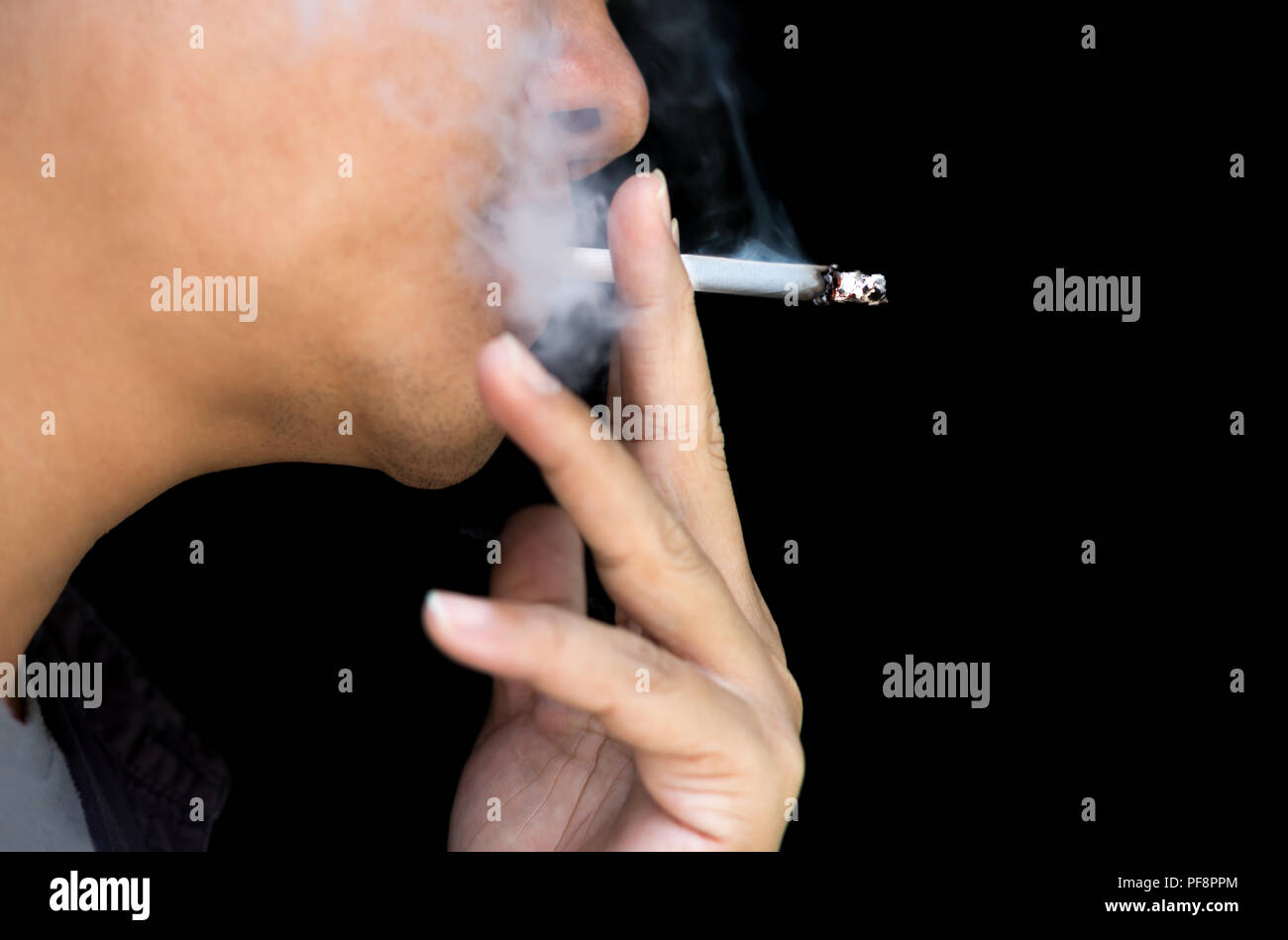 Concept Unidentified smoker lighting up cigarette Stock Photo Alamy