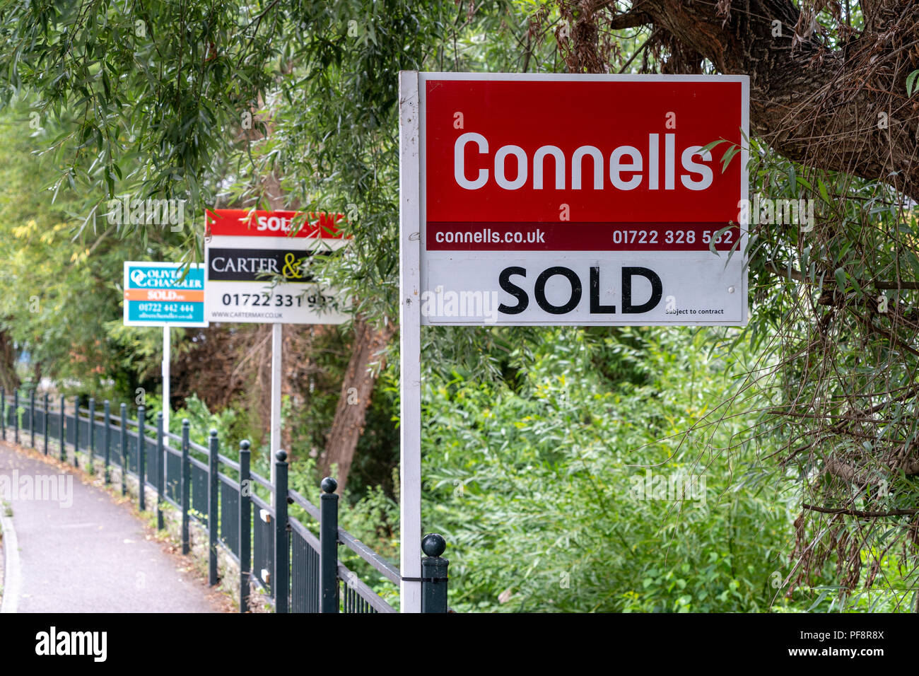 Estate agents boards in a line Stock Photo Alamy