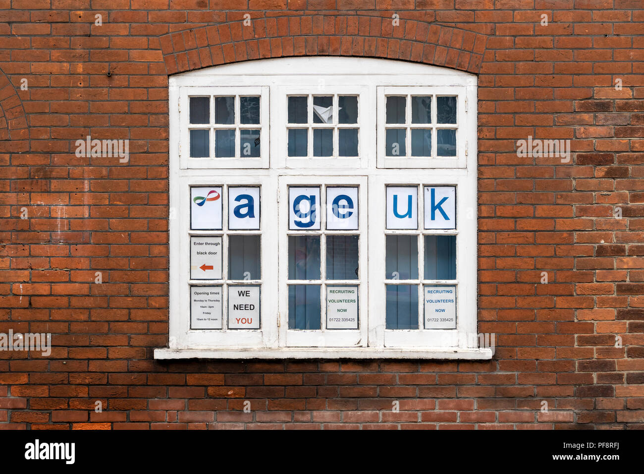 Age UK advertising posters in window Stock Photo - Alamy