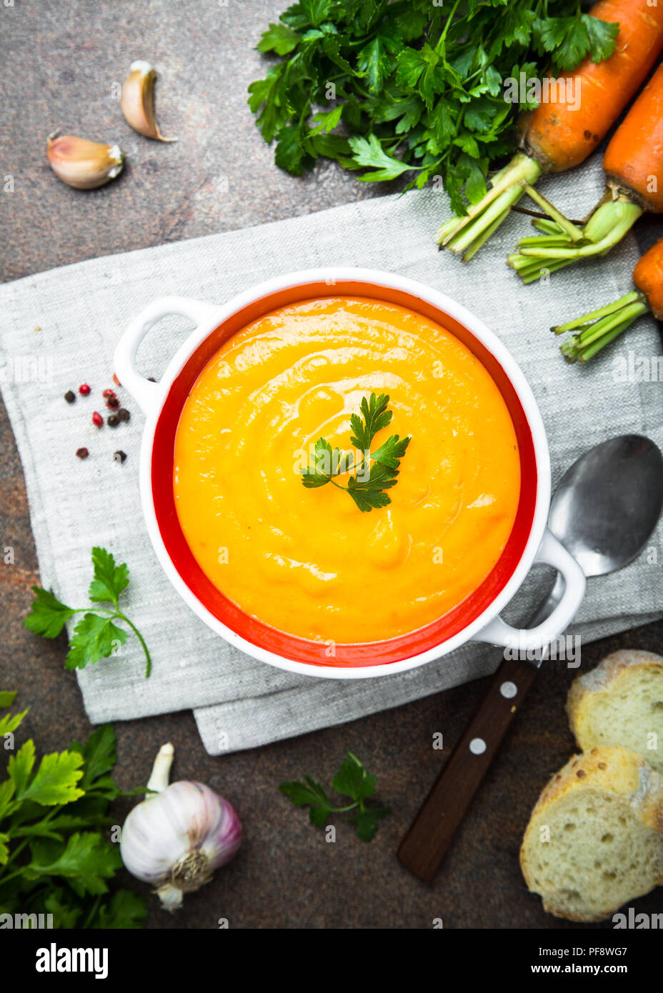 Carrot creamsoup on dark stone table. Vegetarian vegetables soup. Top