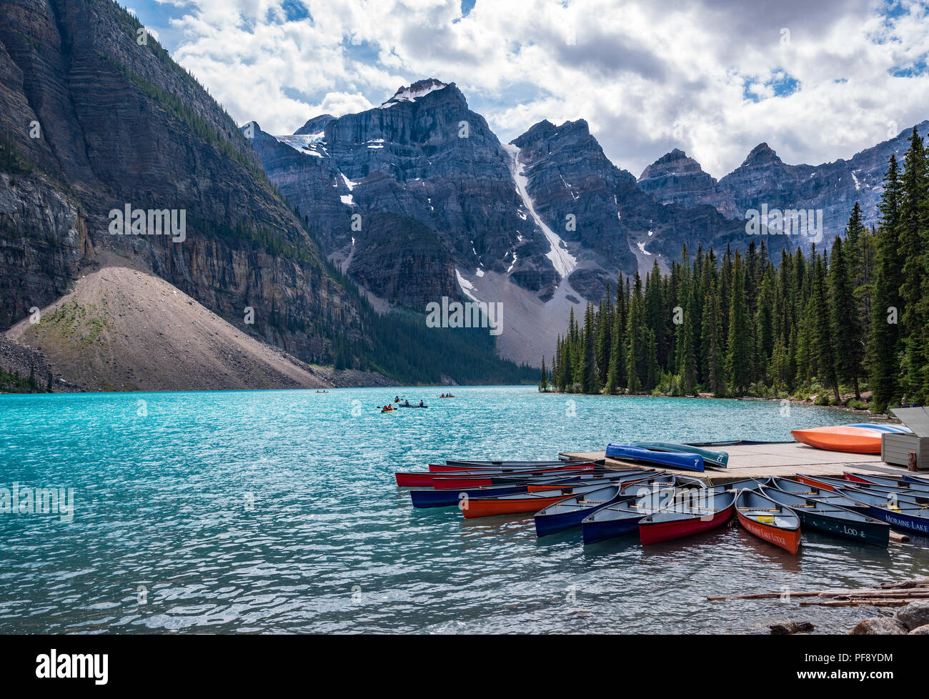 Banff, Canada--August 6, 2018.  Wide angle shot of Boaters on the aqua waters of Moraine Lake surrounded by the Ten Peaks. Stock Photo