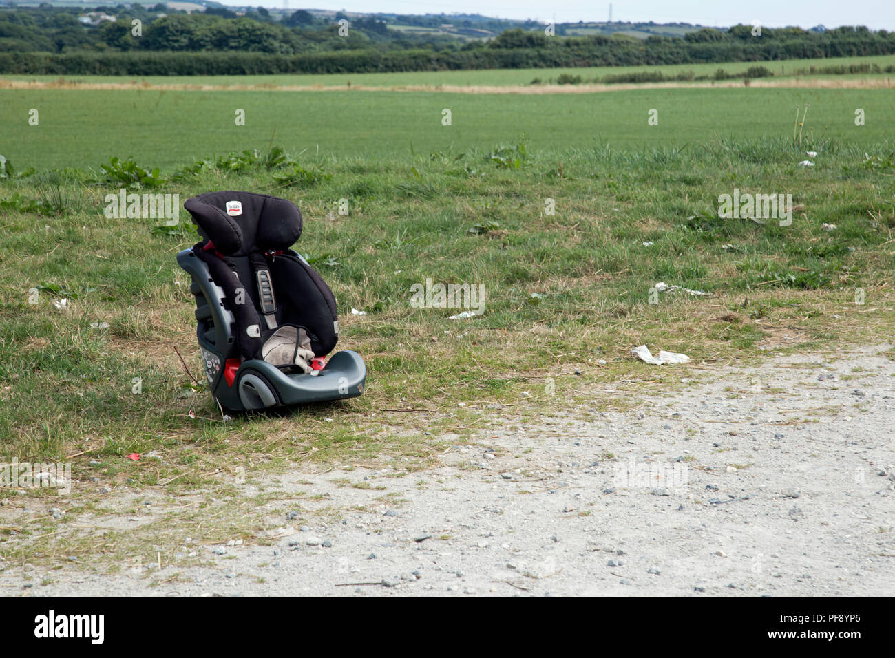 A car baby seat is mysteriously abandoned on a rough patch of land by ...