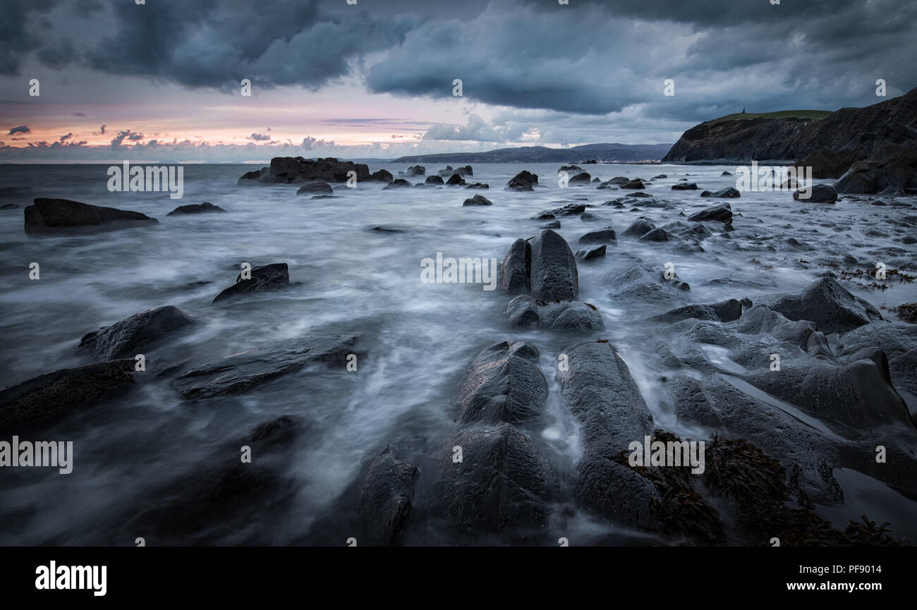 A stormy coastal scene at Borth Beach at sunset in Wales, UK Stock Photo