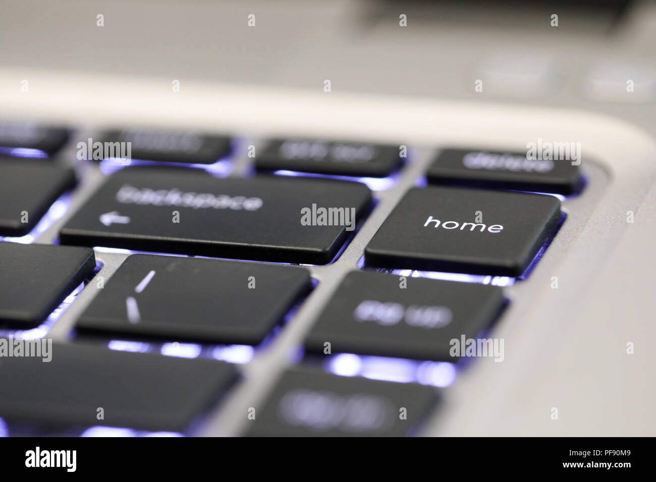 close up of the special computer key board button home. illuminated contemporary modern keyboard character. Stock Photo